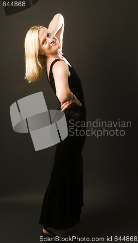 Image of glamorous woman posing in cocktail dress