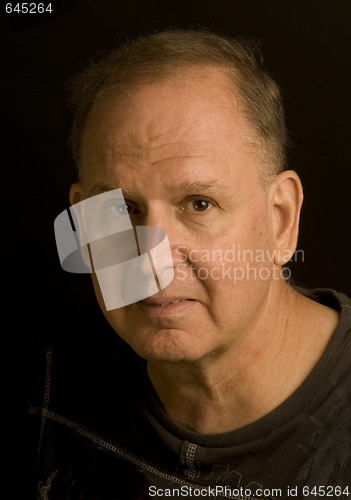 Image of senior man retired head shot portrait in tee shirt