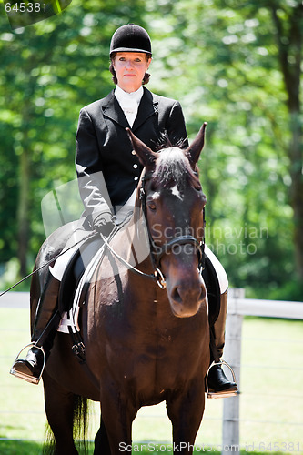 Image of Horseback riding senior woman