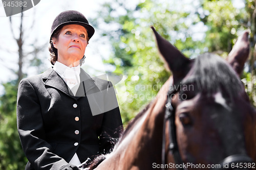 Image of Horseback riding senior woman