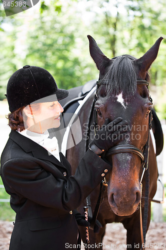 Image of Horseback riding senior woman