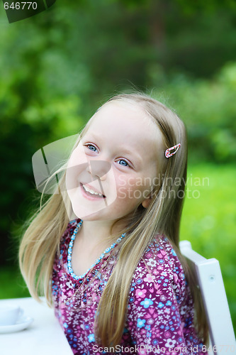 Image of Smiling little girl outdoors.