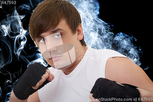 Image of Portrait of the young fighter in a smoke