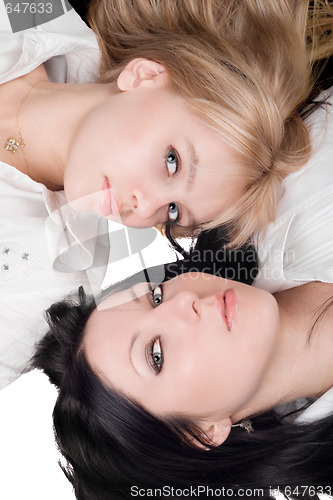 Image of Portrait of lying beautiful young blonde and brunette