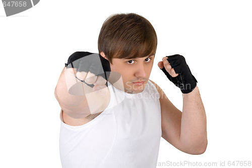 Image of Young man throwing a punch. Isolated on white