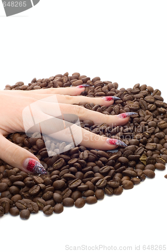 Image of Female hand and coffee beans