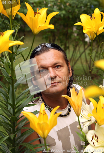 Image of The man among yellow lilies