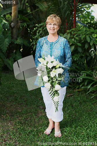 Image of Mature woman with flowers