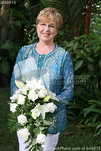 Image of Mature woman with flowers.