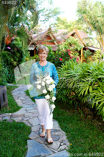 Image of Mature woman with flowers.