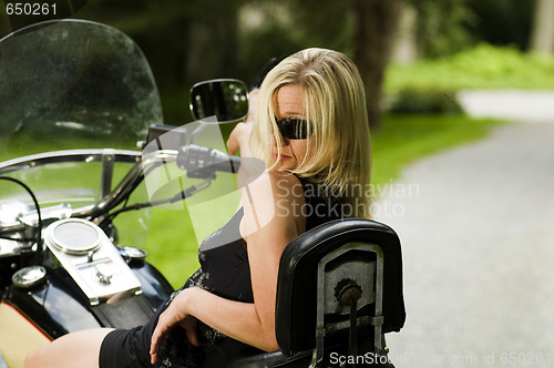 Image of sexy blond woman on large motorcycle