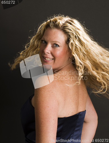 Image of glamorous woman posing in cocktail dress