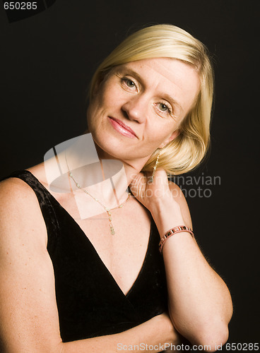 Image of glamorous woman posing in cocktail dress