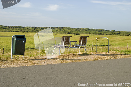 Image of An empty bench in the dunes looking out to sea