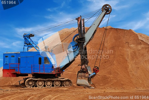 Image of Heavy electric excavator in sandpit