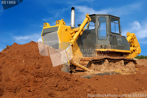 Image of Close view of heavy bulldozer moving sand in sandpit