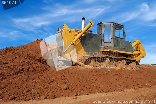 Image of heavy bulldozer moving sand in sandpit
