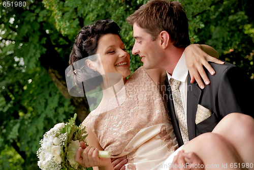 Image of Happy smiling wedding couple outdoors. 