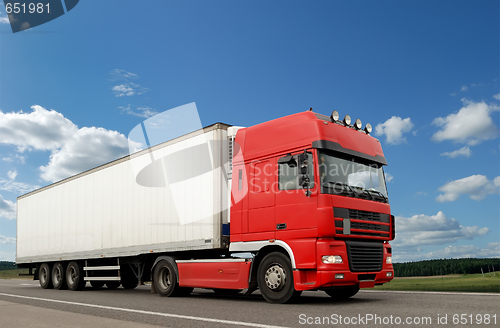 Image of Red lorry with white trailer over blue sky
