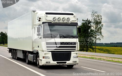 Image of front of white truck on the highway