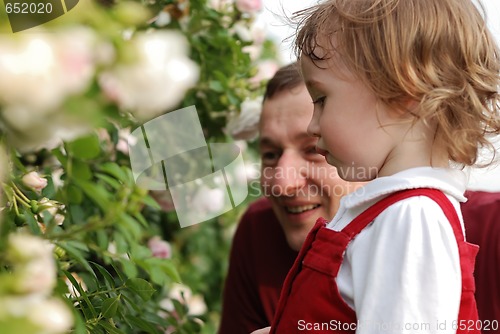 Image of little girl, her father and flowers