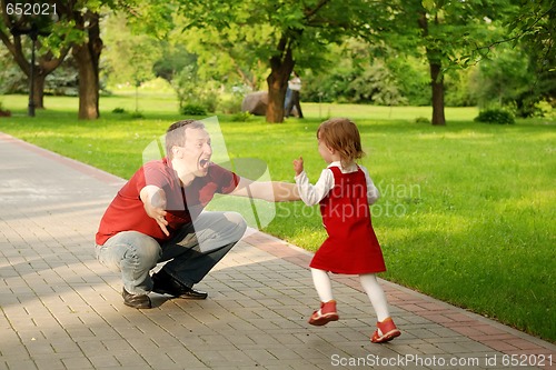 Image of man playing with little girl