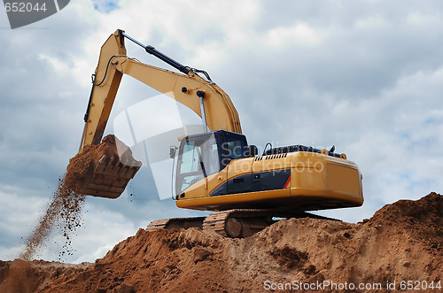 Image of Excavator with earth in the bucket