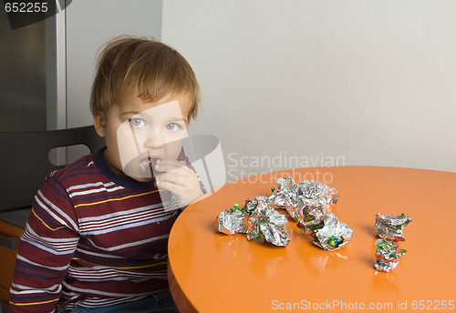 Image of Boy eating chocolates