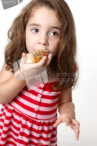 Image of Pretty little girl eating a doughnut
