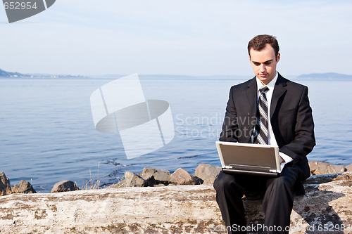 Image of Caucasian businessman with laptop