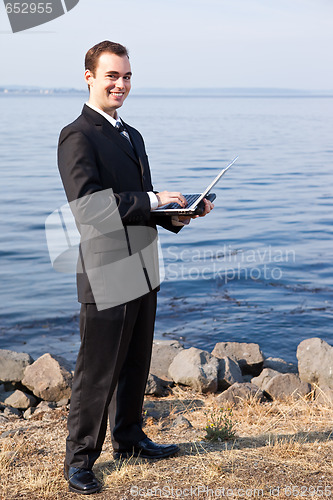 Image of Caucasian businessman with laptop