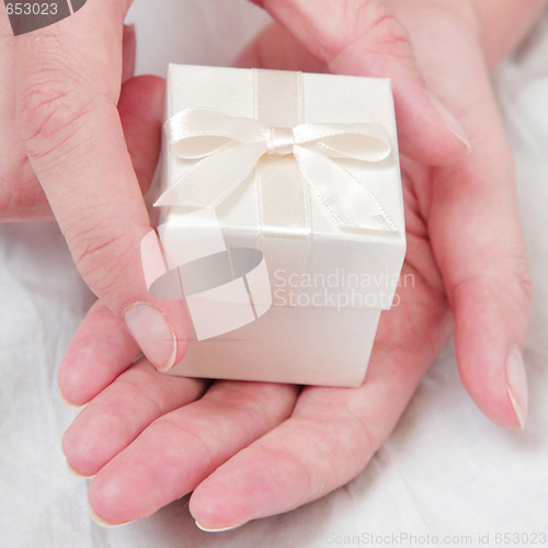 Image of Hand and and White Gift