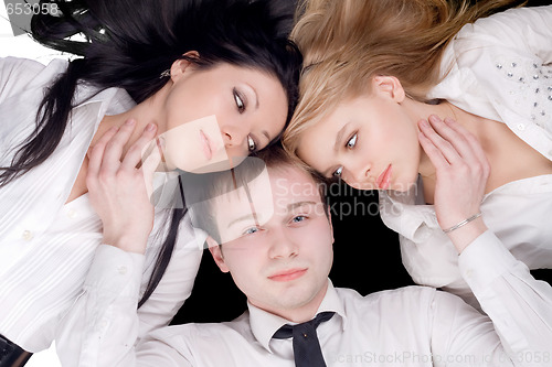 Image of Portrait if the young man and two pretty women