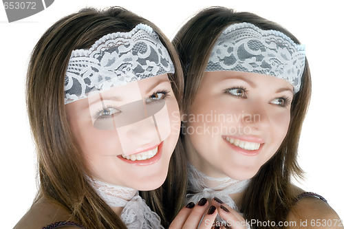 Image of Portrait of the smiling young woman near a mirror