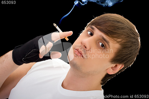 Image of Young  man with a cigarette. Isolated on black