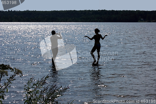 Image of Man photographes the girl. Silhouettes