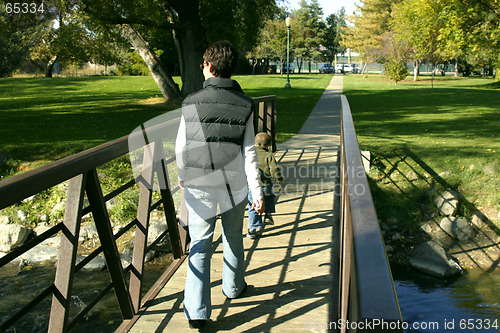 Image of Mother and Son walking on the Park Bridge