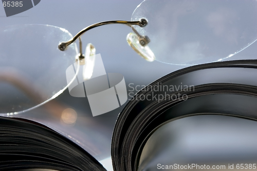 Image of Close up on a pair of Glasses and the Magazine