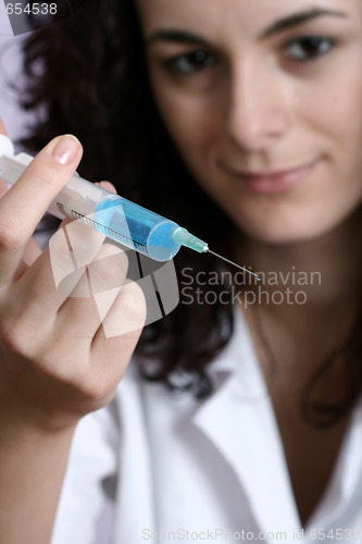 Image of Portrait of a young doctor with syringa.