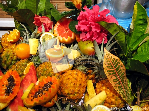 Image of Tropical cocktail fruits, decoration with flowers and leaves