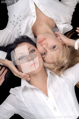 Image of Portrait of the two lying attractive girlfriends