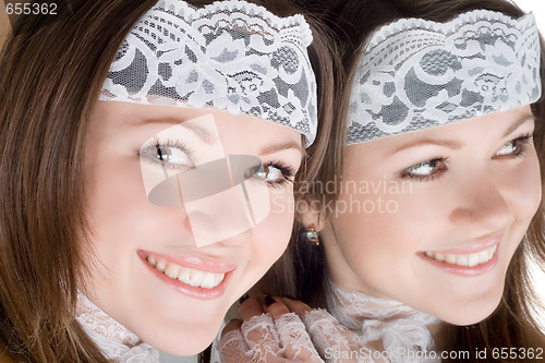 Image of Portrait of the smiling girl near a mirror