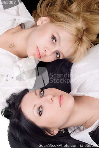 Image of Portrait of lying young blonde and brunette