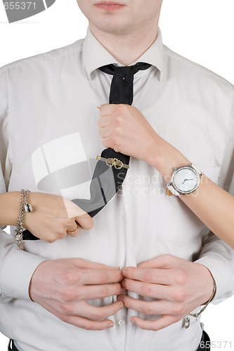 Image of Young man, a tie and female hands. Isolated on white