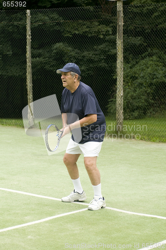 Image of senior man playing tennis