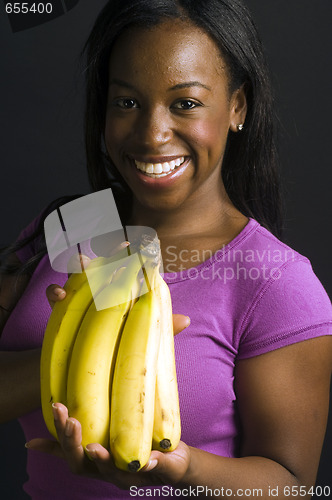 Image of portrait smiling happy latin woman with bananas