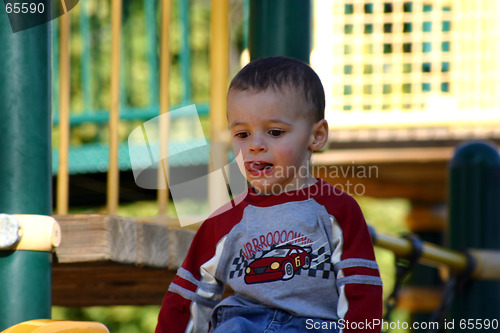 Image of Little Boy Sitting on the Slider Top