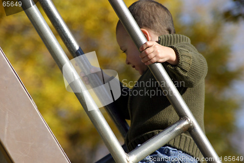 Image of Kid Climbing Up the Slider with Hand in Focus