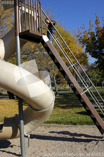 Image of Kid Climbing Up the Slider with Hand in Focus