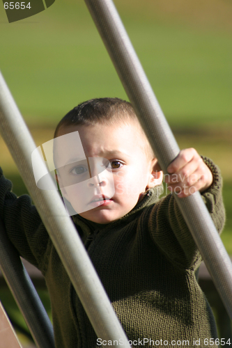 Image of Kid Climbing Up the Slider with Hand in Focus